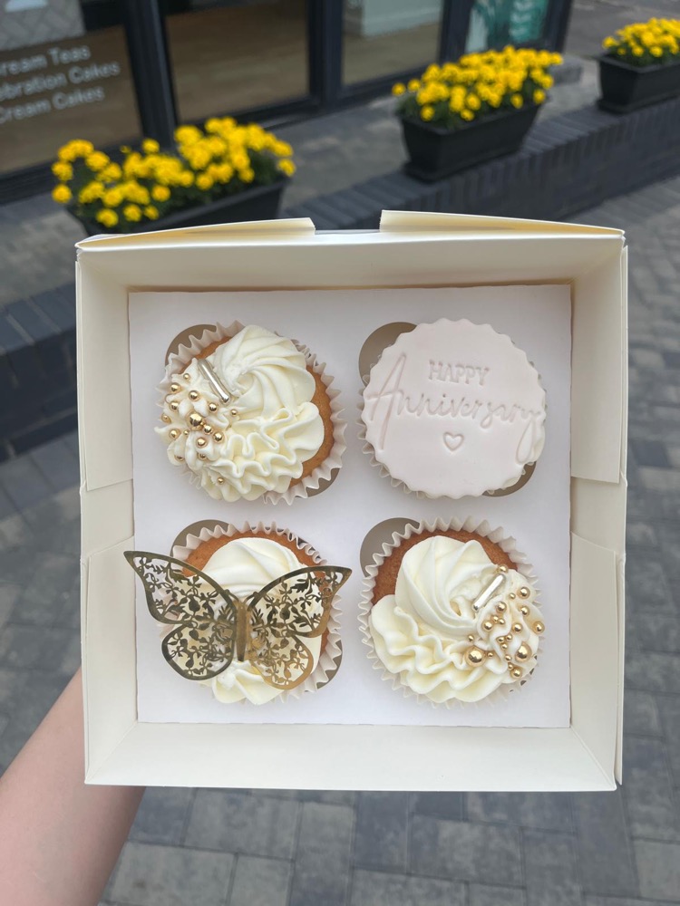 Gift box of cream cupcakes decorated for an anniversary