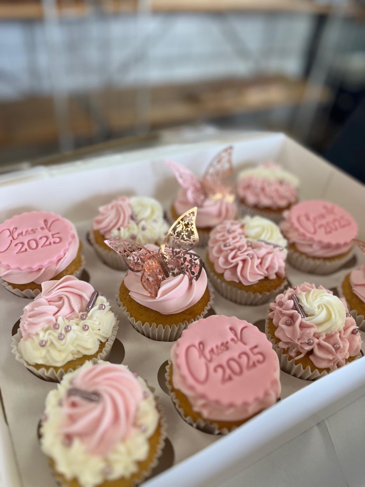 Pink and white cupcakes decorated for a graduation celebration
