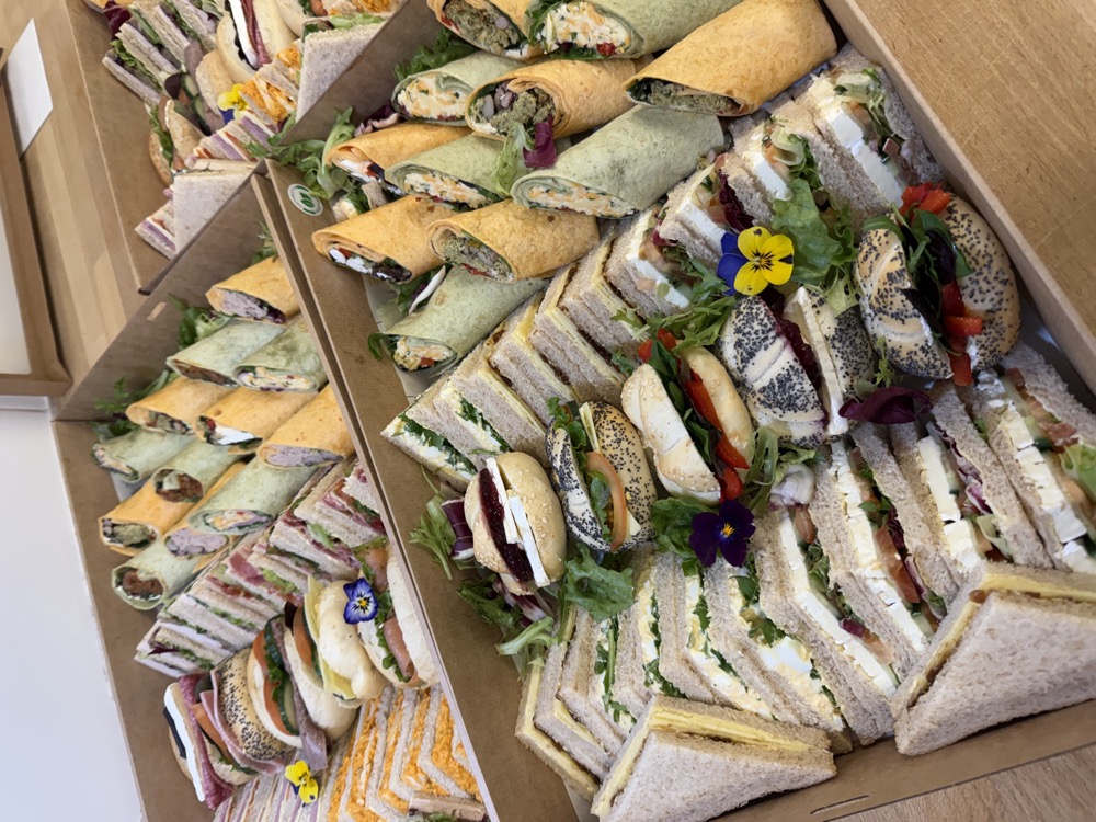 Catering box of sandwiches and mini pizzas
